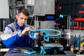 Young designer engineer using a 3D printer in laboratory