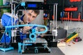 Young designer engineer using a 3D printer in laboratory