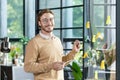 A young designer, programmer, freelancer man is standing in the office, holding a tablet, drawing a progress graph on a