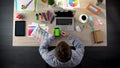 Young designer scrolling phone with green screen, using app for finding job Royalty Free Stock Photo