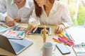 Young designers teamwork working with color samples for selection on office desk,