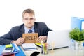 Young desperate businessman holding help sign looking worried suffering work stress at computer desk Royalty Free Stock Photo