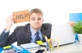 Young desperate businessman holding help sign looking worried suffering work stress at computer desk Royalty Free Stock Photo