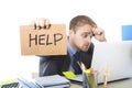 Young desperate businessman holding help sign looking worried suffering work stress at computer desk Royalty Free Stock Photo