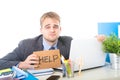 Young desperate businessman holding help sign looking worried suffering work stress at computer desk Royalty Free Stock Photo