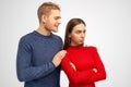 Young desperate European man holds shoulders of girlfriend, looks with miserable expression, asks for forgiveness, feels guilty. Royalty Free Stock Photo