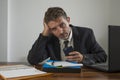 Young desperate and frustrated businessman working stressed and upset sitting at office computer desk serious feeling sad Royalty Free Stock Photo