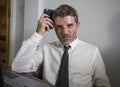 Young desperate and frustrated businessman working stressed and upset sitting at office computer desk serious feeling sad Royalty Free Stock Photo