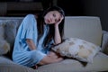 Young desperate sad and depressed Asian Korean woman sitting at home sofa couch suffering depression problem and anxiety crisis Royalty Free Stock Photo