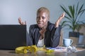Young desperate and stressed african american business woman working at laptop computer desk at office suffering stress feeling sa Royalty Free Stock Photo