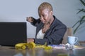 Young desperate and stressed african american business woman working at office desk suffering stress feeling overwhelmed punching Royalty Free Stock Photo