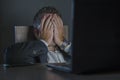 Young desperate and stressed businessman working overtime at office laptop computer desk feeling anxious and overwhelmed suffering Royalty Free Stock Photo