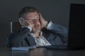 Young desperate and stressed businessman working overtime at office laptop computer desk feeling anxious and overwhelmed suffering Royalty Free Stock Photo