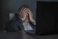 Young desperate and stressed businessman working overtime at office laptop computer desk feeling anxious and overwhelmed suffering Royalty Free Stock Photo