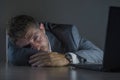 Young desperate and stressed businessman working overtime at office laptop computer desk feeling anxious and overwhelmed suffering Royalty Free Stock Photo