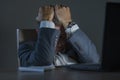 Young desperate and stressed businessman working overtime at office laptop computer desk feeling anxious and overwhelmed suffering Royalty Free Stock Photo