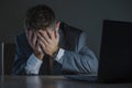 Young desperate and stressed businessman working overtime at office laptop computer desk feeling anxious and overwhelmed suffering Royalty Free Stock Photo