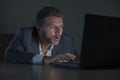 Young desperate and stressed businessman working overtime at office laptop computer desk feeling anxious and overwhelmed suffering Royalty Free Stock Photo