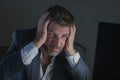 Young desperate and stressed businessman working overtime at office laptop computer desk feeling anxious and overwhelmed suffering Royalty Free Stock Photo