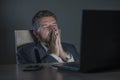 Young desperate and stressed businessman working overtime at office laptop computer desk feeling anxious and overwhelmed suffering Royalty Free Stock Photo