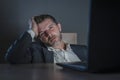 Young desperate and stressed businessman working overtime at office laptop computer desk feeling anxious and overwhelmed suffering Royalty Free Stock Photo