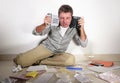 Young desperate and stressed sad man worried holding calculator accounting domestic payments and debt having money problem domesti Royalty Free Stock Photo