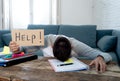 Young desperate student in stress working and studying holding a help sign
