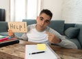 Young desperate student in stress working and studying holding a help sign Royalty Free Stock Photo