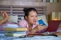 Young desperate and tired Asian Chinese university student woman feeling overwhelmed and stressed preparing exam studying with Royalty Free Stock Photo