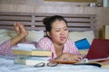 Young desperate and tired Asian Korean teen university student feeling overwhelmed and stressed preparing exam studying with Royalty Free Stock Photo