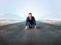 Businessman kneeling in ready position Royalty Free Stock Photo