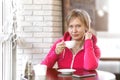 A young determined, successful business woman in sportswear sits after a workout in a cafe