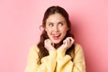 Young devious girl licking her lips and teeth, looking aside with thoughtful face, having interesting idea, thinking Royalty Free Stock Photo