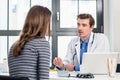 Young devoted doctor listening with attention to his patient Royalty Free Stock Photo