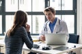 Young devoted doctor listening with attention to his patient Royalty Free Stock Photo