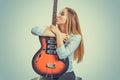 Woman kissing electric guitar devoted