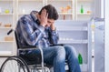 Young disabled injured man opening the fridge door Royalty Free Stock Photo