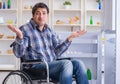 Young disabled injured man opening the fridge door Royalty Free Stock Photo