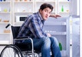 Young disabled injured man opening the fridge door Royalty Free Stock Photo