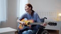 A young disabled lady is playing the guitar and singing songs Royalty Free Stock Photo