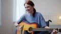 A young disabled lady is playing the guitar and singing songs Royalty Free Stock Photo