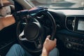 Young disabled man driver with artificial prosthetic hand driving vehicle car.