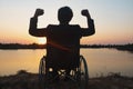 Young disabled man with field background.He is wearing sitting on wheelchair Royalty Free Stock Photo