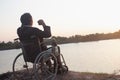 Young disabled man with field background.He is wearing sitting on wheelchair Royalty Free Stock Photo