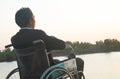 Young disabled man with field background.He is wearing sitting on wheelchair Royalty Free Stock Photo