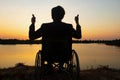 Young disabled man with field background.He is wearing sitting on wheelchair Royalty Free Stock Photo