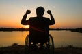 Young disabled man with field background.He is wearing sitting on wheelchair Royalty Free Stock Photo