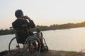 Young disabled man with field background.He is wearing sitting on wheelchair Royalty Free Stock Photo