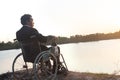 Young disabled man with river background.He is sitting on wheelchair and looking into river Royalty Free Stock Photo