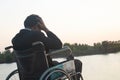 Young disabled man with river background.He is sitting on wheelchair Royalty Free Stock Photo